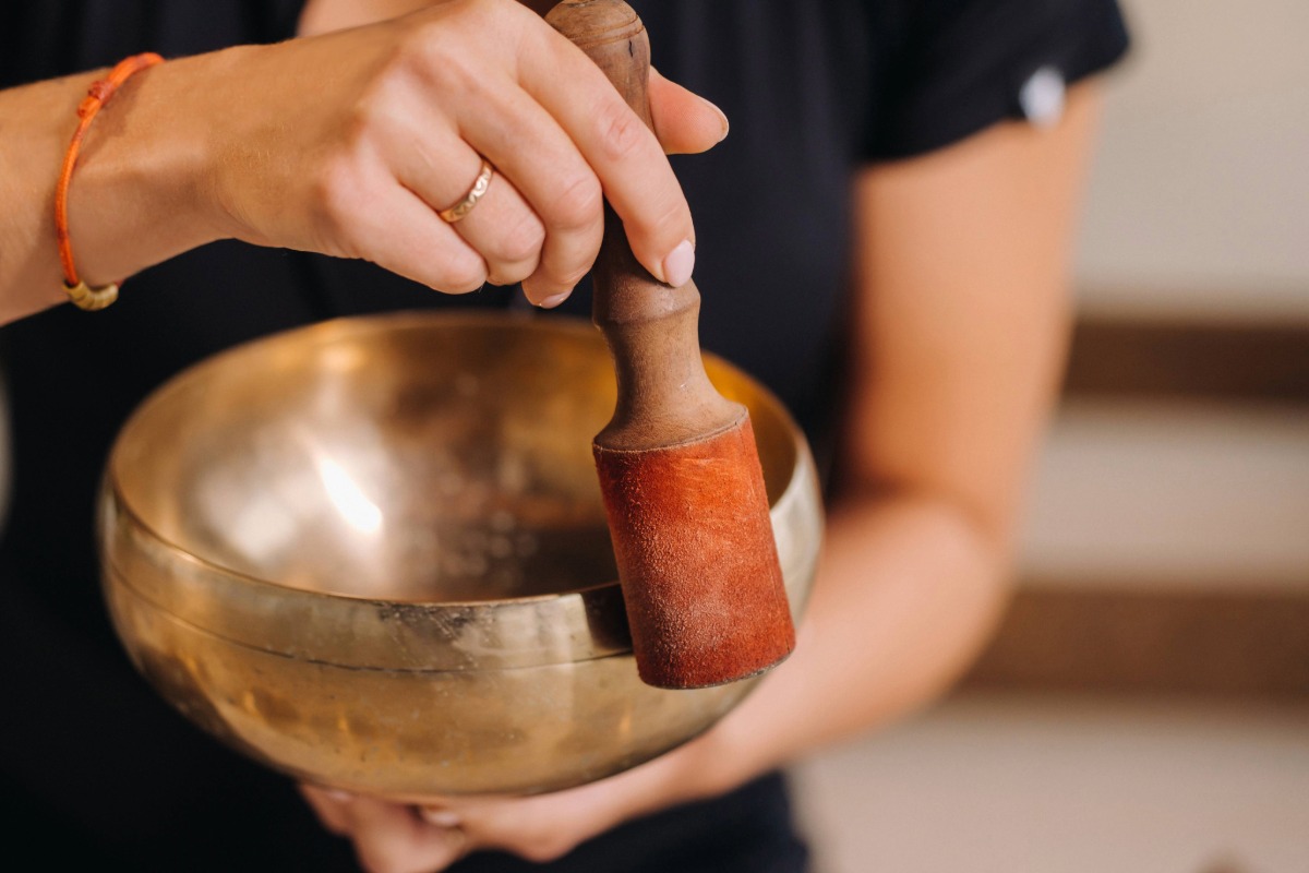 woman holding a Tibetan singing bowl
